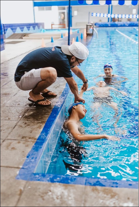 Children in a group swim lesson with instructor