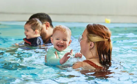 Infant in pool with parent