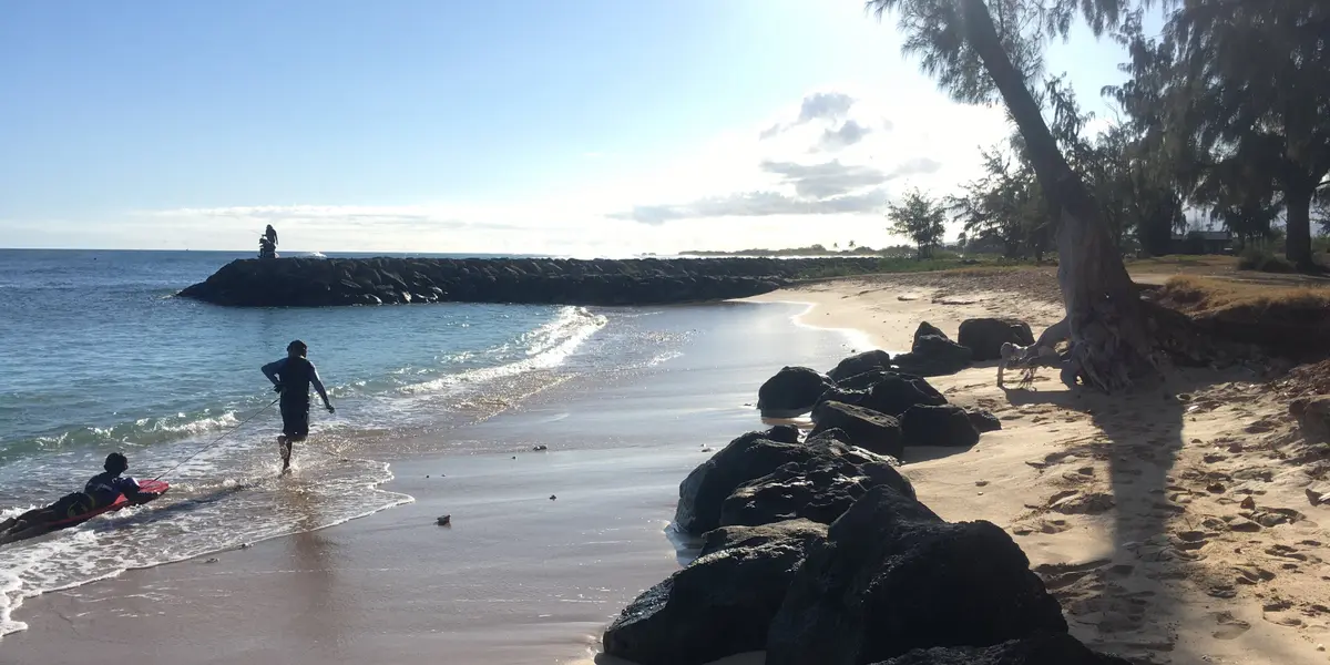Parent holding child near water